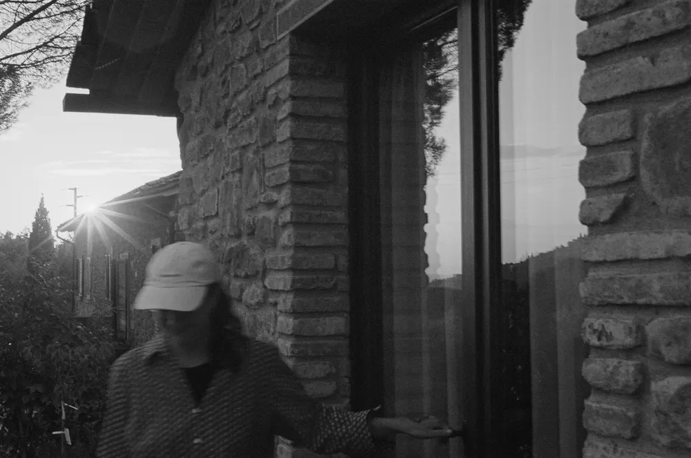 Blurry portrait infront of a stone house